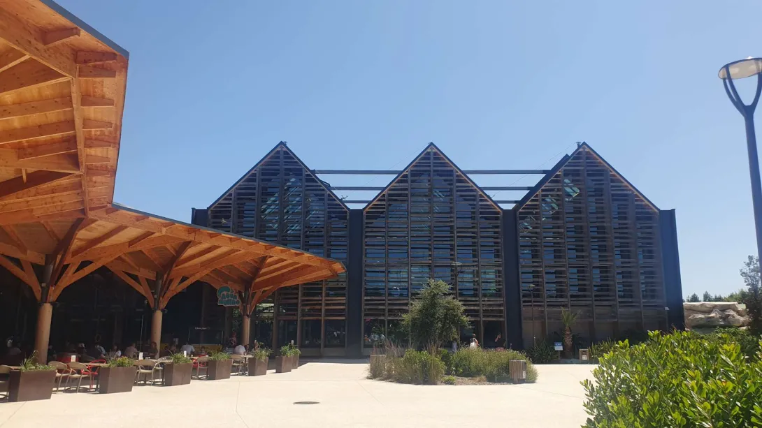 La place du village avec les corolles en bois sur son pourtour et l'Aqua Mundo au fond